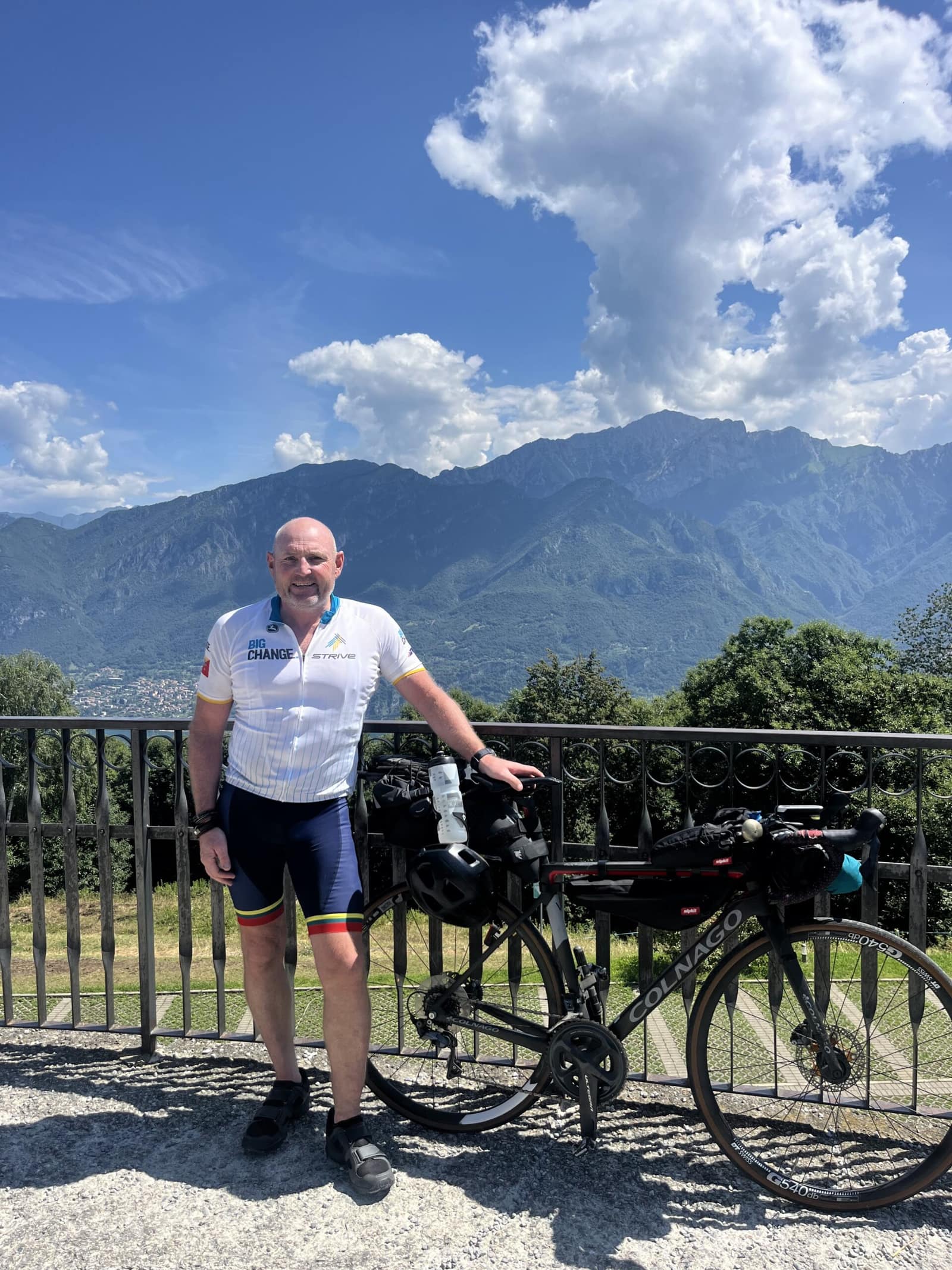 Scully with his bike, mountains behind